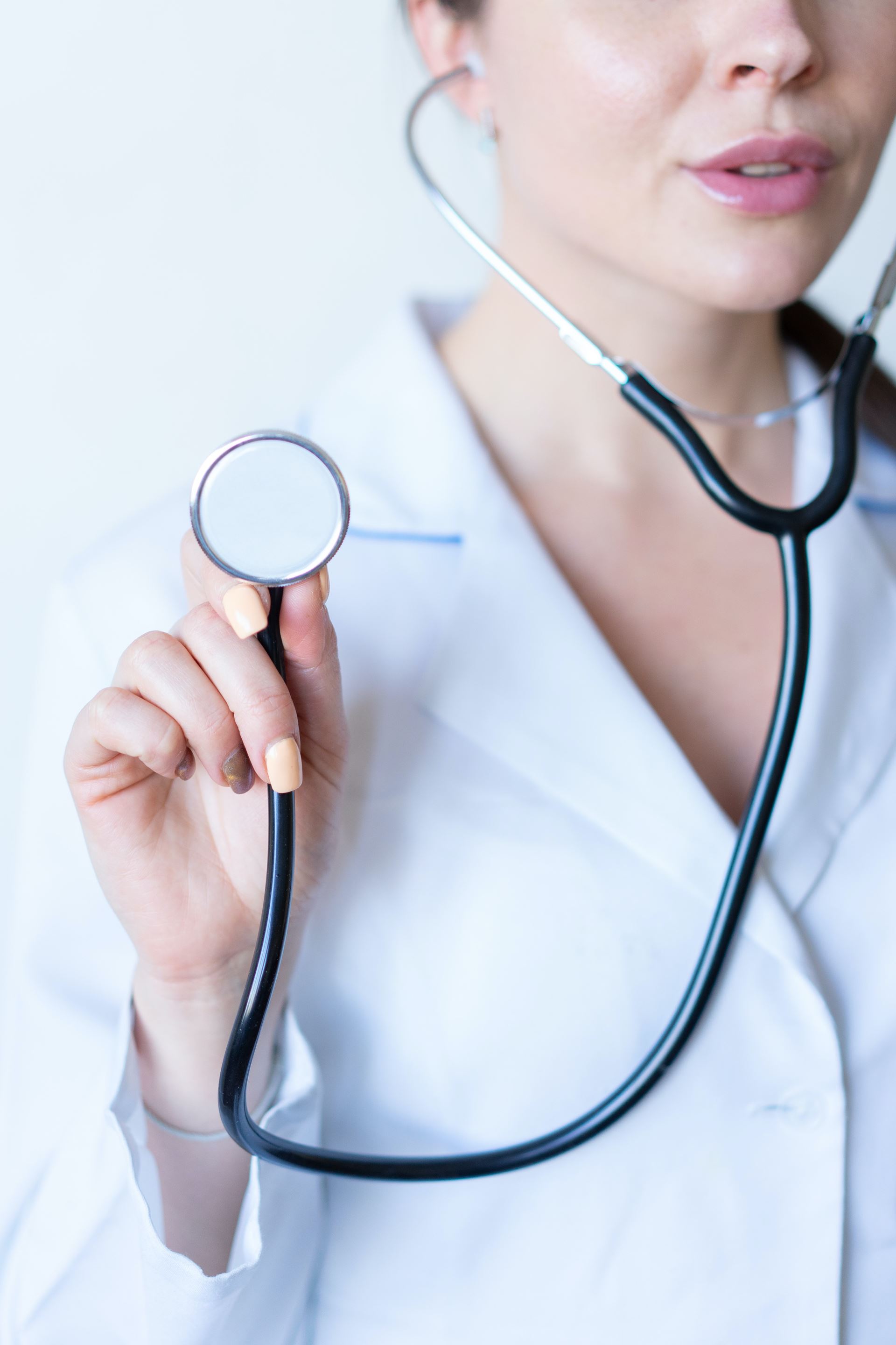 a female clinician holding a stethoscope